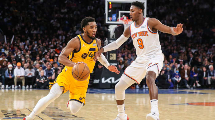 Jazz guard Donovan Mitchell drives on Knicks forward RJ Barrett.